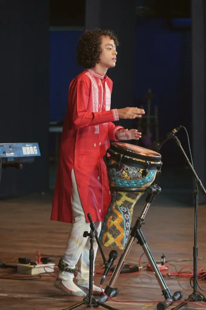 Aurum performing on the djembe under stage lights
