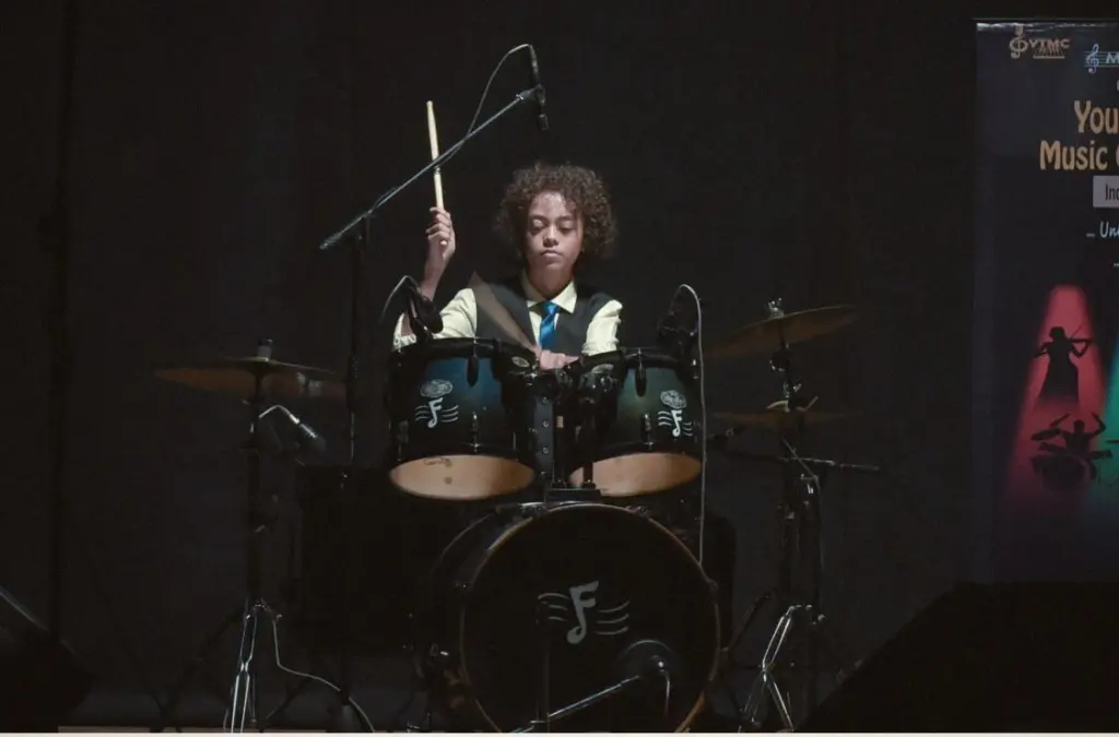 Aurum with drumsticks raised at the kit