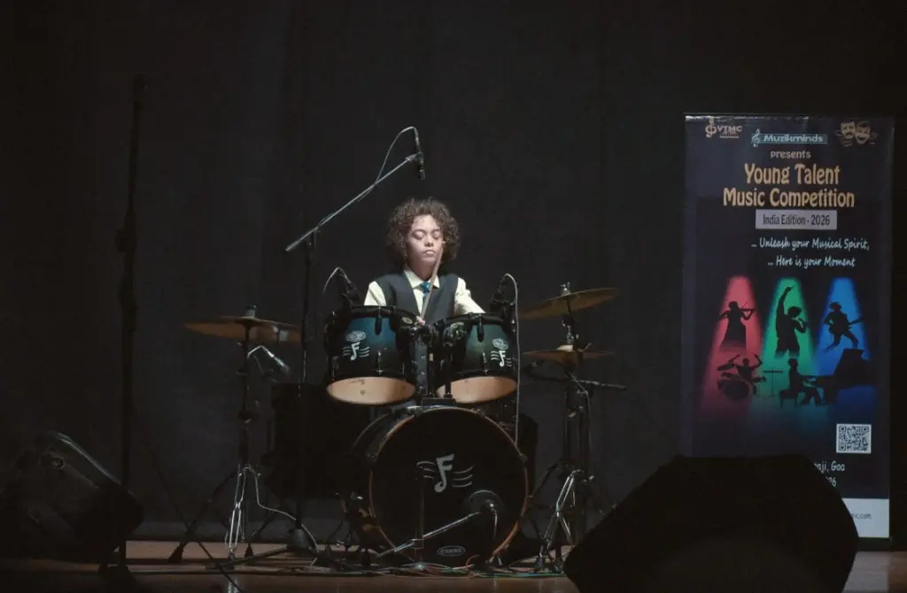 Aurum performing on drums under stage lights