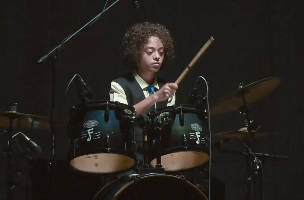 Close view of Aurum striking the drums