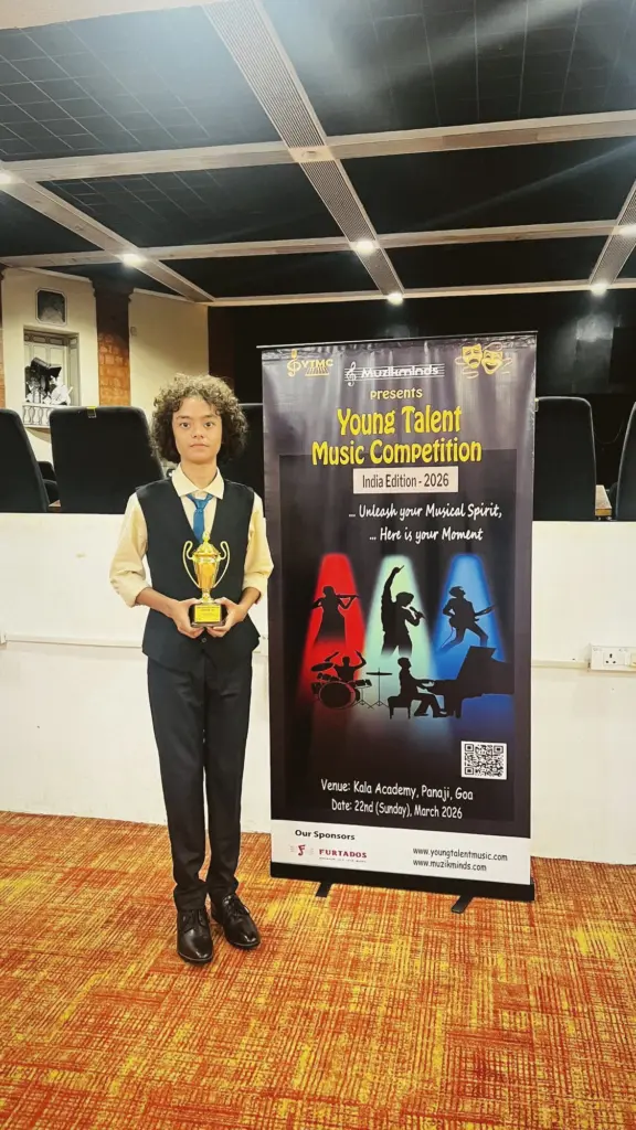 Aurum standing beside an event banner