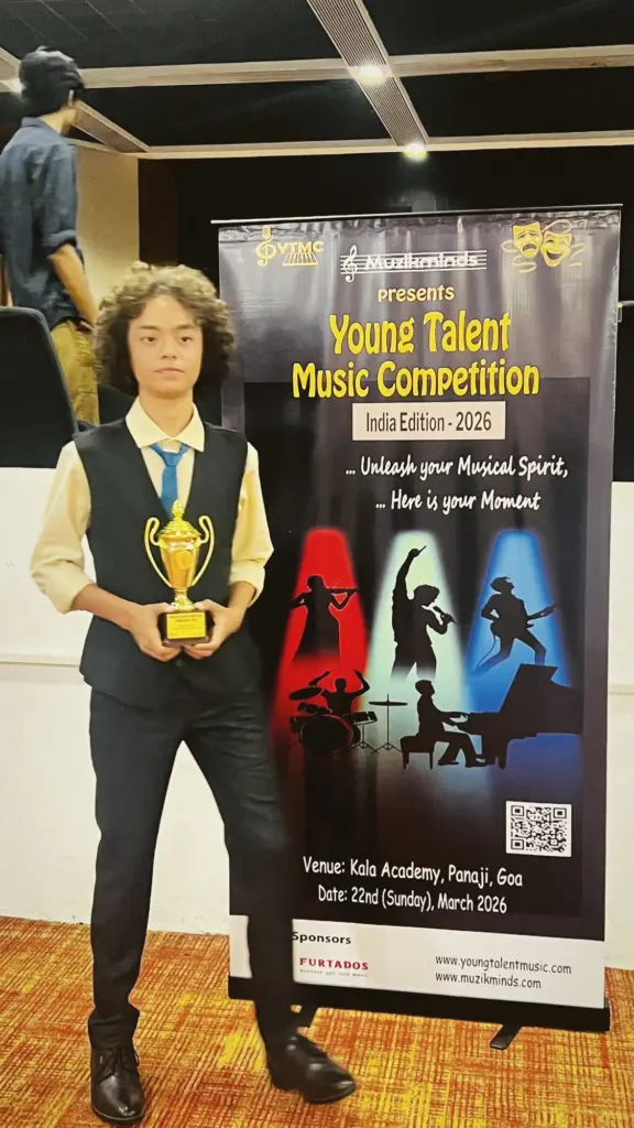 Aurum smiling beside an event banner